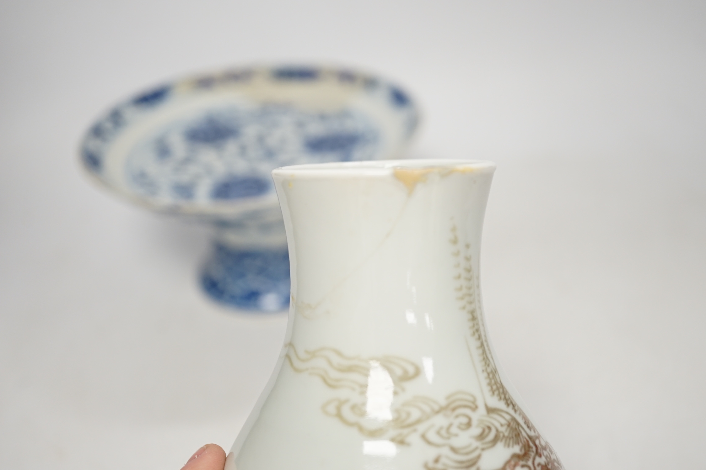 A Chinese underglaze copper red ‘herder and goats’ vase, Kangxi six character mark but Republic period and a Chinese blue and white lotus stem dish, six character Guangxu mark and period, both damaged
